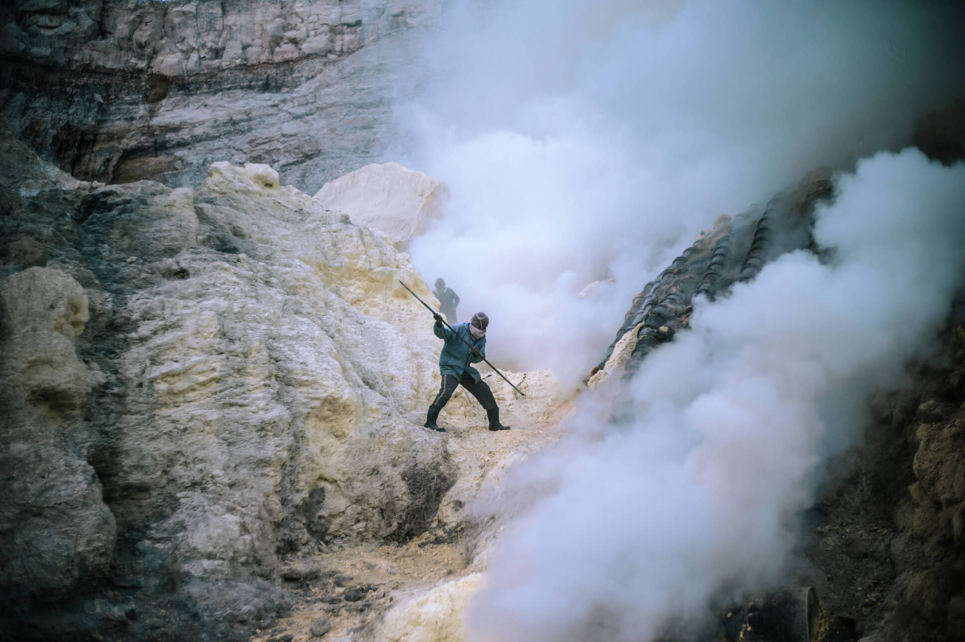 Man with mask in mountains of sulphur